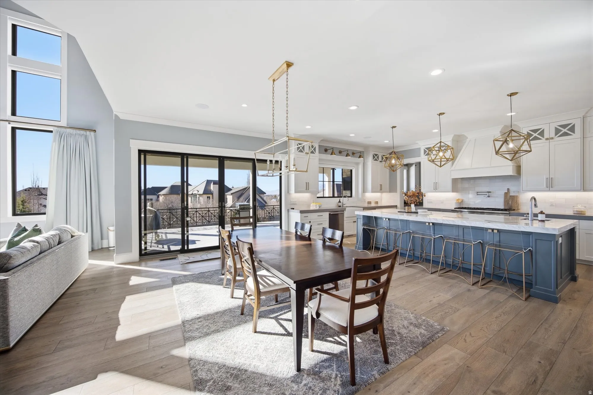 Dining room featuring light wood-style floors, a chandelier, and a high ceiling