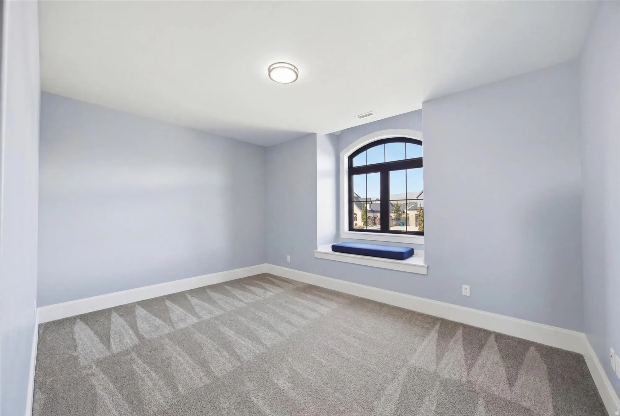 Empty room with baseboards and light carpet