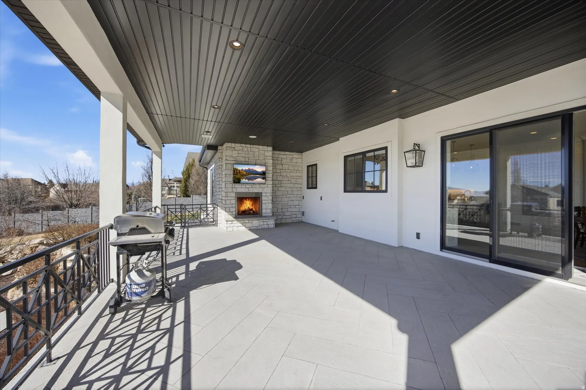 View of patio / terrace featuring an outdoor stone fireplace and area for grilling