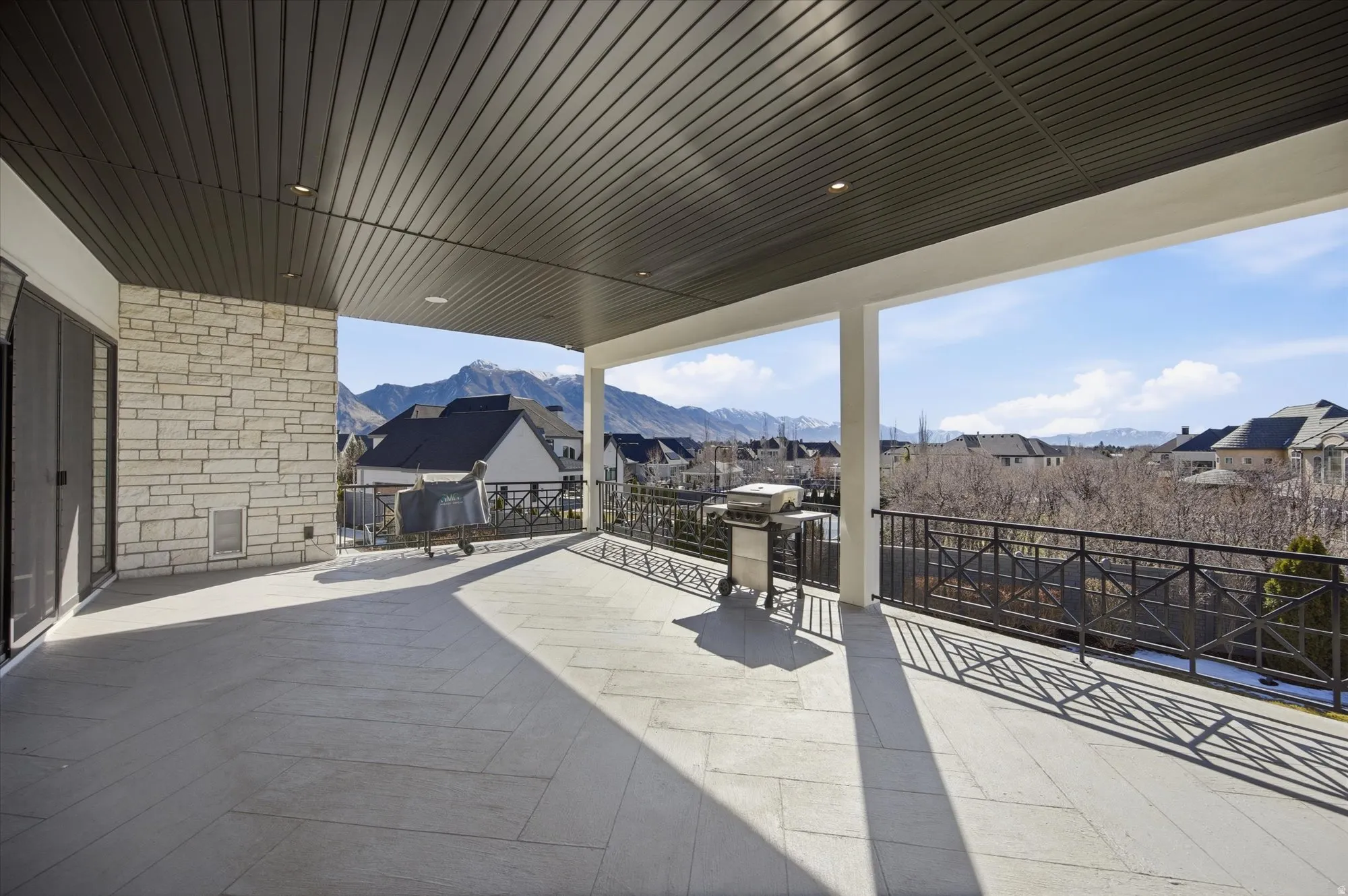 View of patio / terrace featuring a residential view, grilling area, and a mountain view