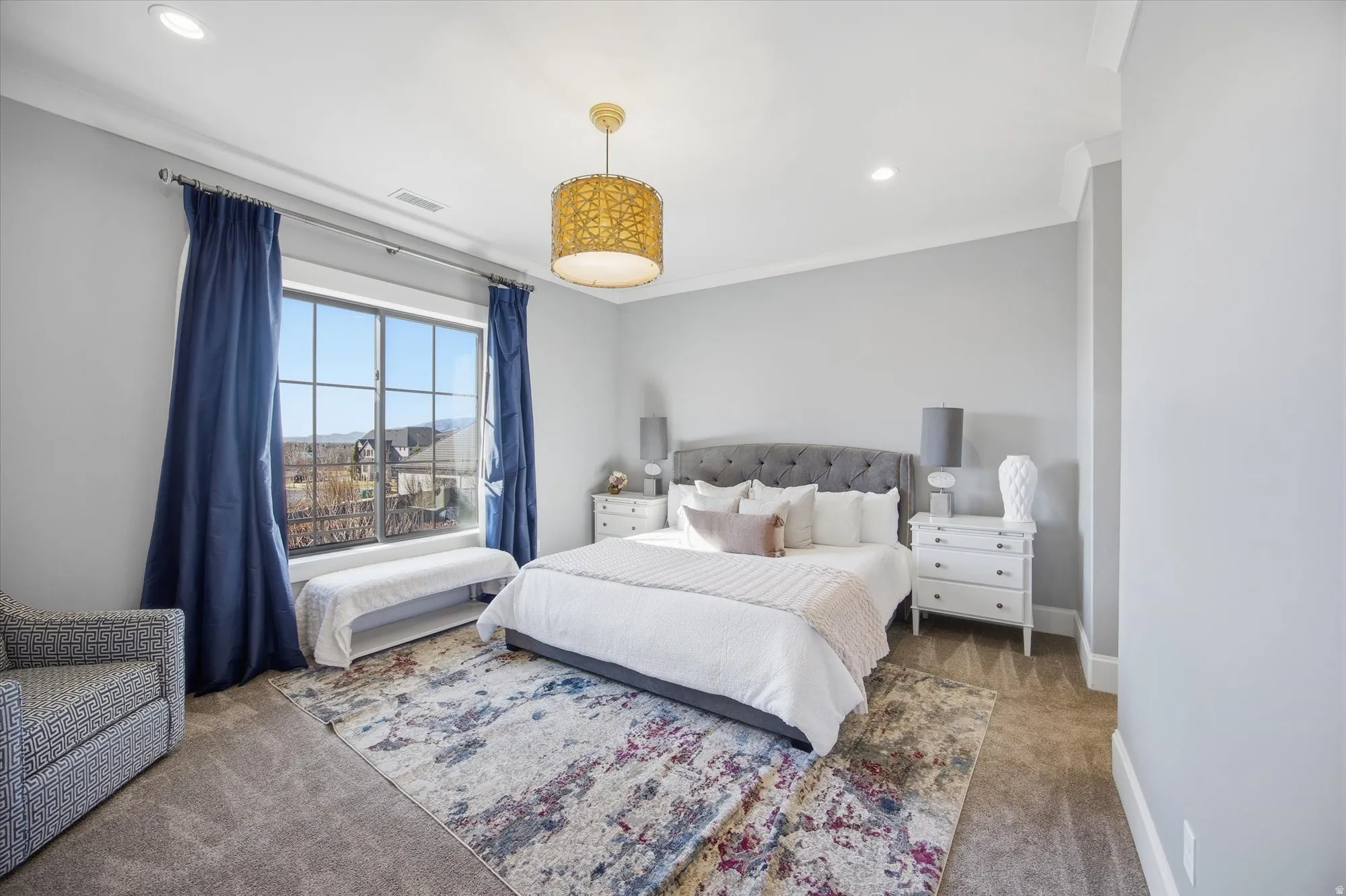 Carpeted bedroom with recessed lighting and ornamental molding