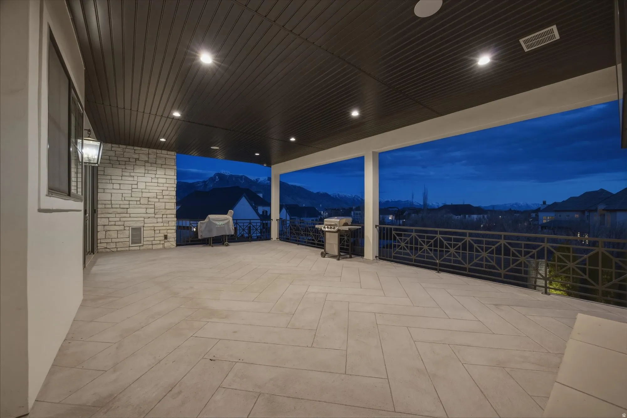 Patio at twilight with a patio, a mountain view, and area for grilling