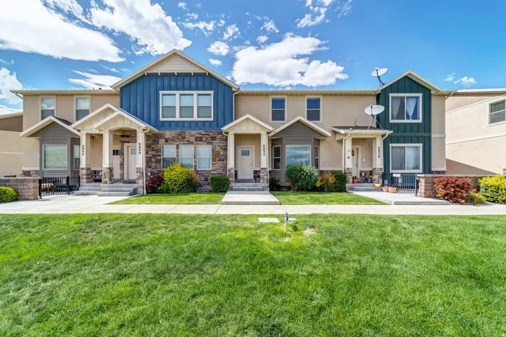 Craftsman-style house featuring board and batten siding and a front yard