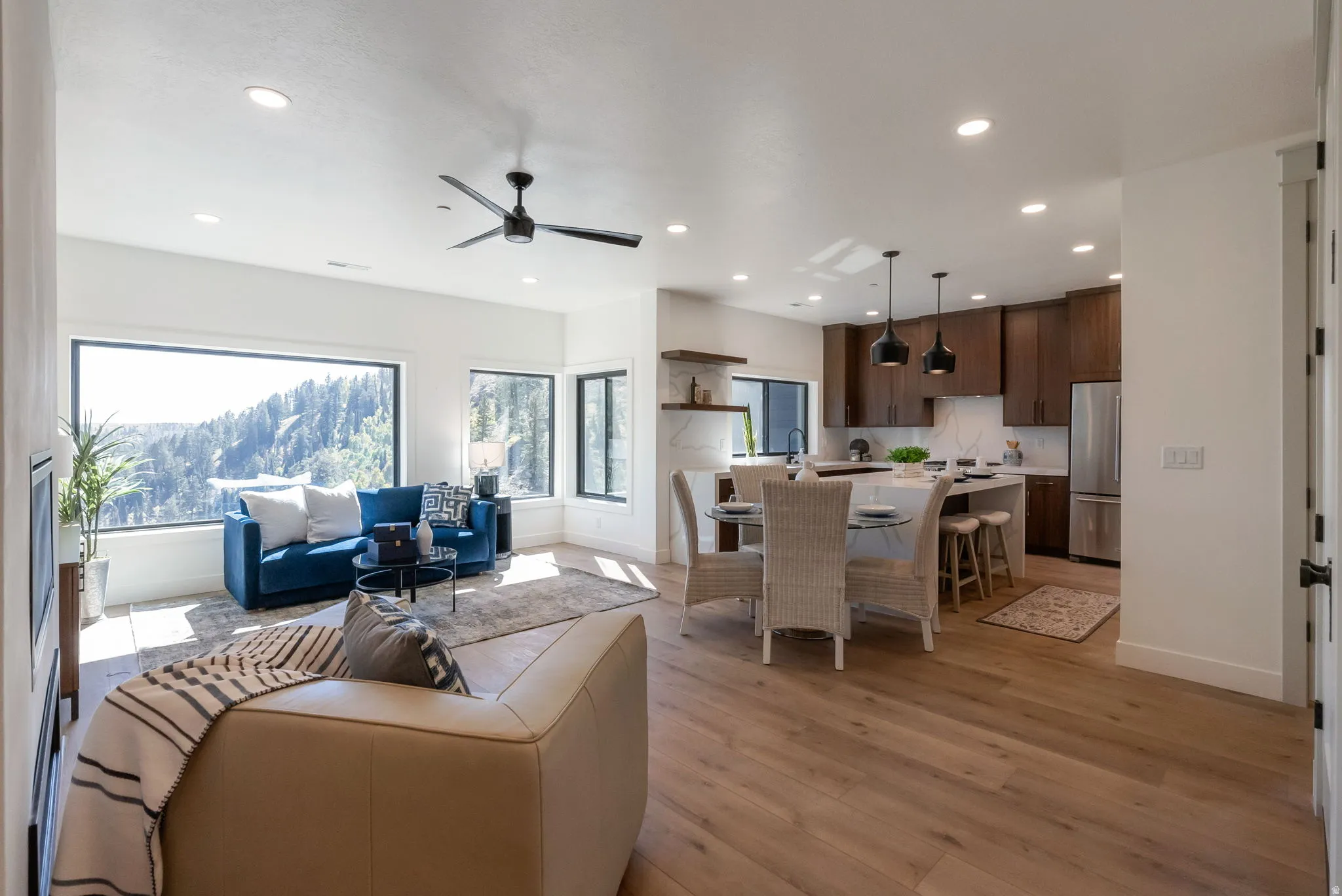 Living area with recessed lighting, ceiling fan, and light wood-type flooring