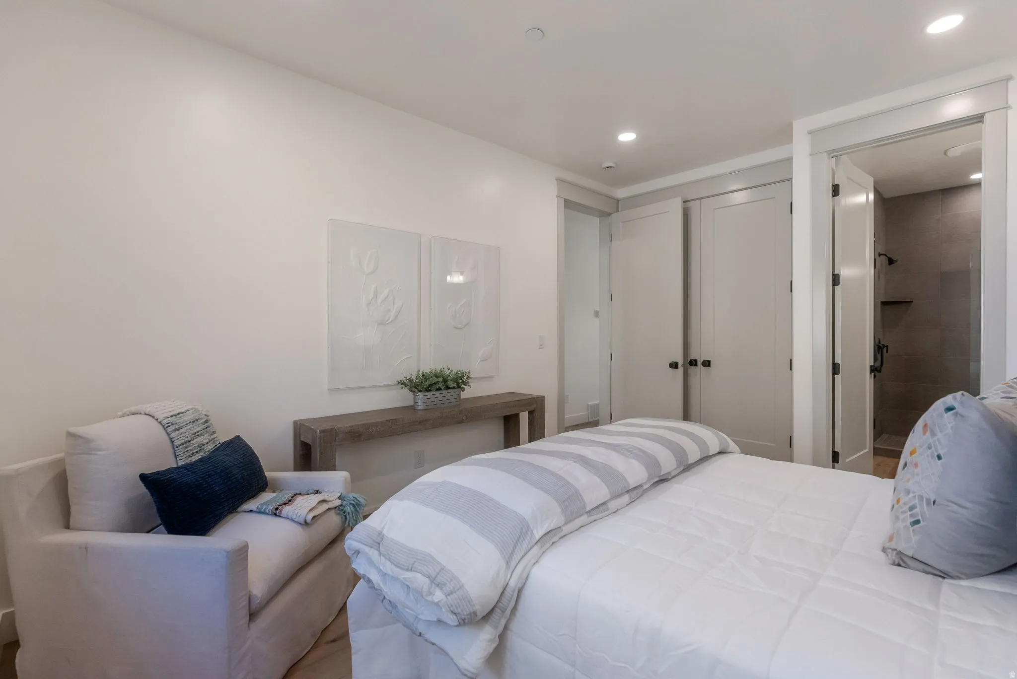 Bedroom featuring recessed lighting and connected bathroom