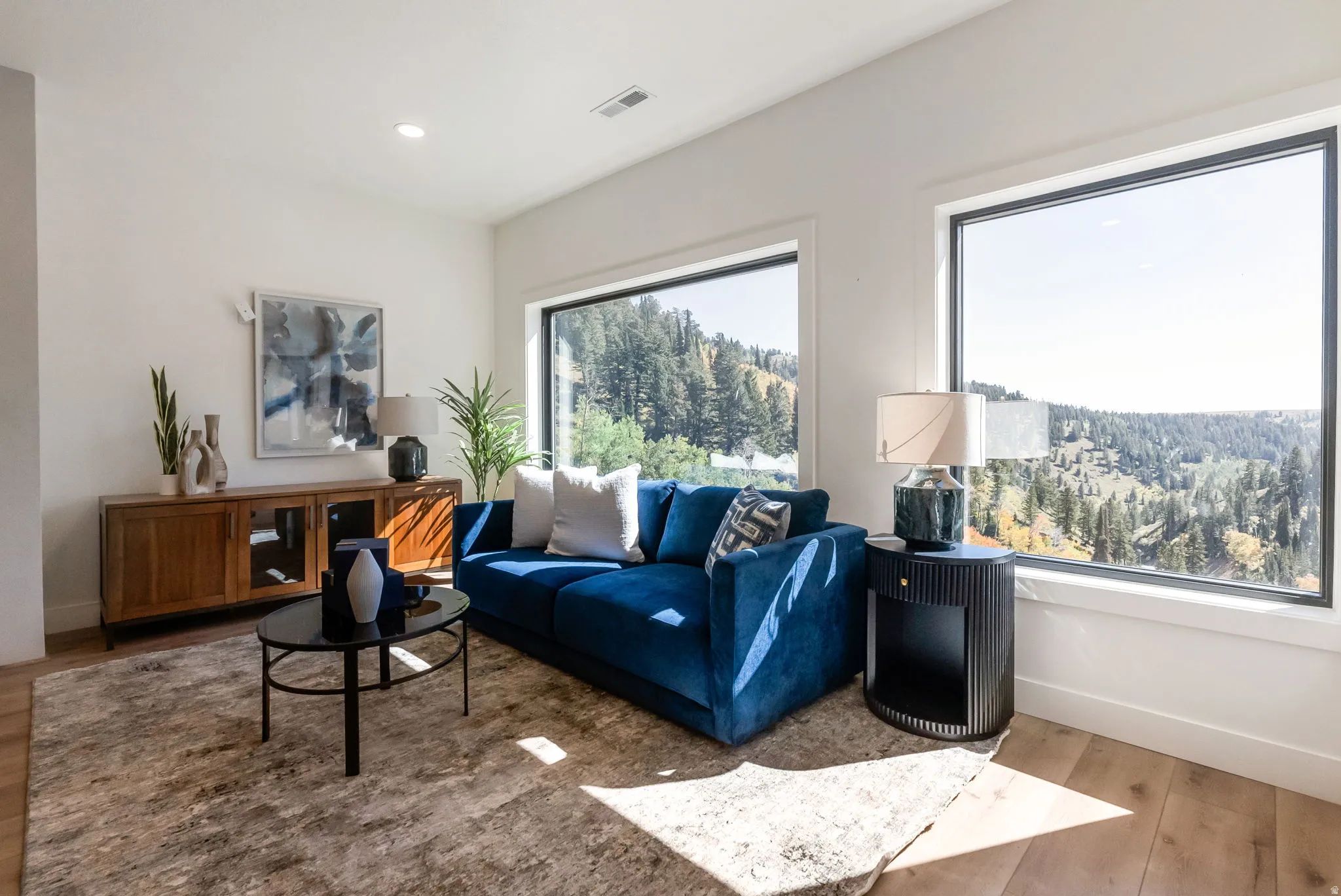 Living area with wood finished floors and recessed lighting
