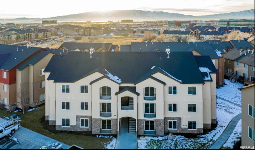 Snowy aerial view featuring a residential view and a mountain view