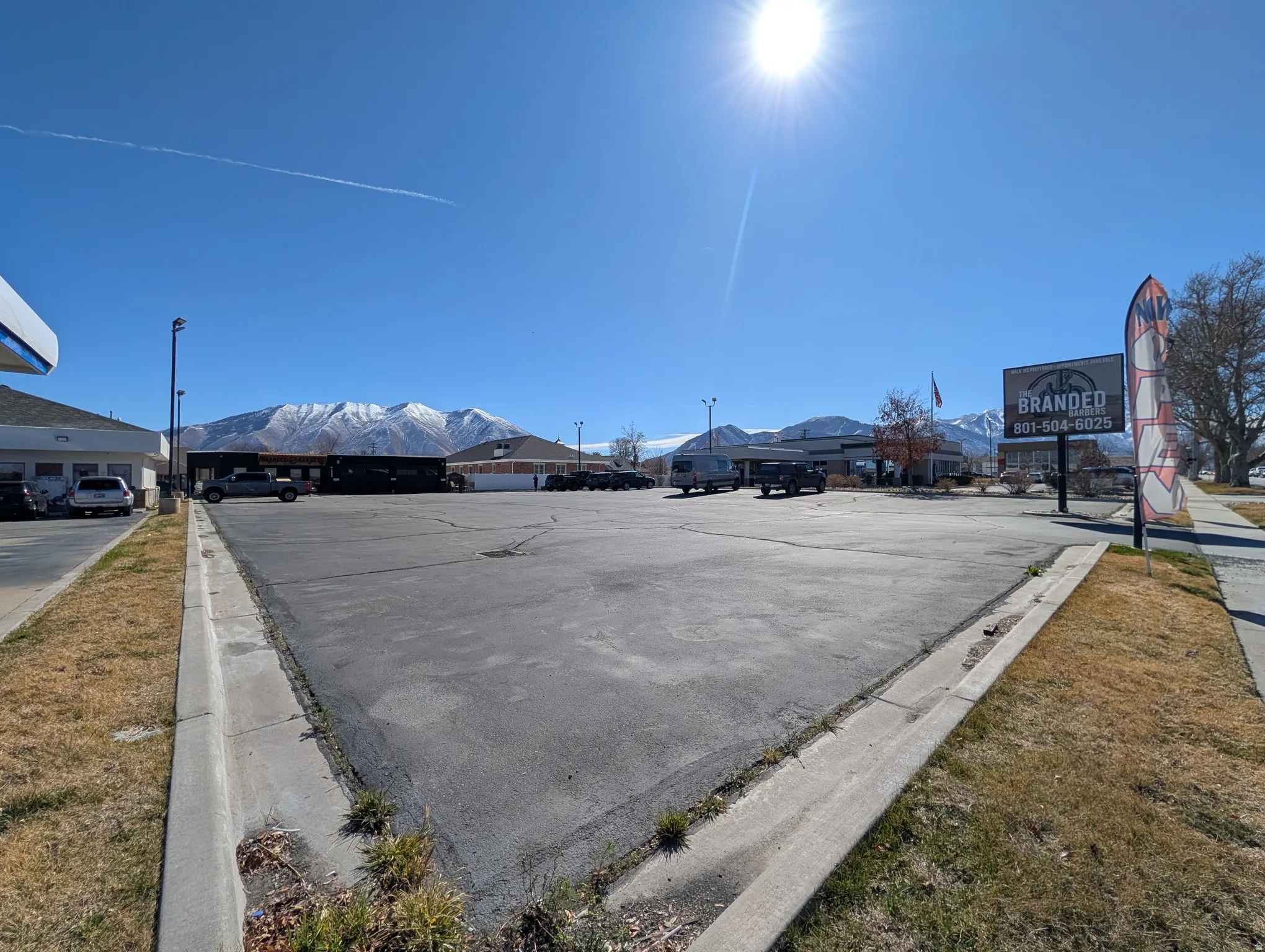 Uncovered parking lot featuring a mountain view