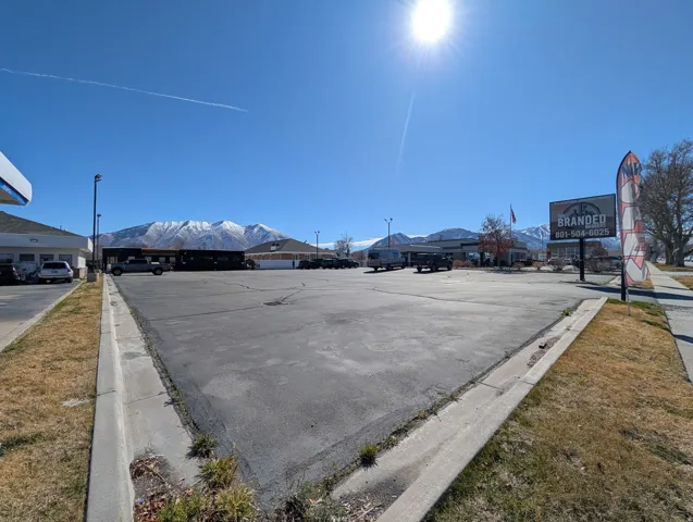Uncovered parking lot featuring a mountain view