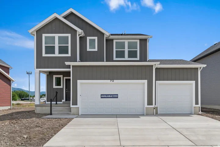 Modern two-story residence featuring gray vertical siding and white trim