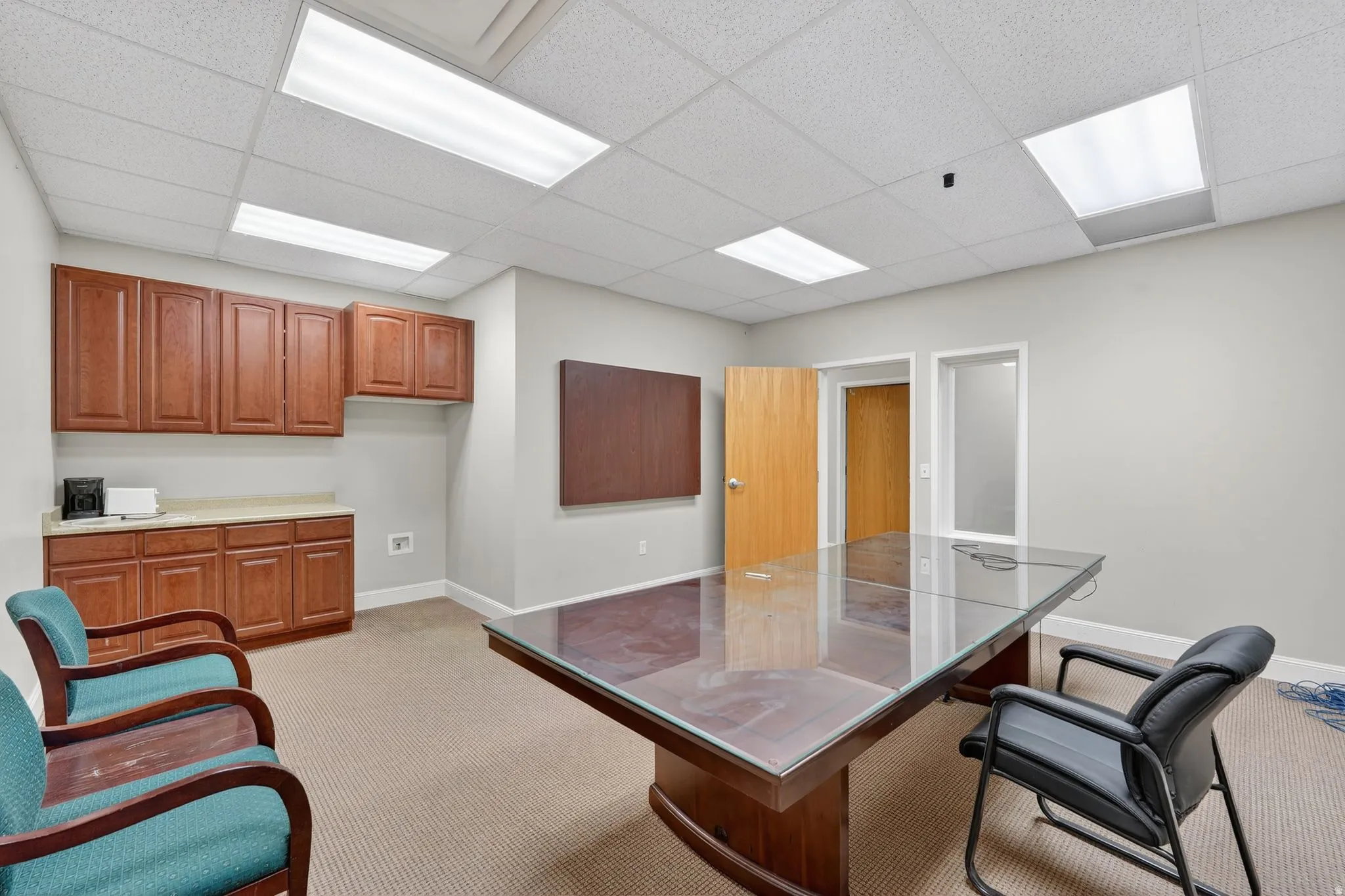 Home office featuring light carpet and a drop ceiling