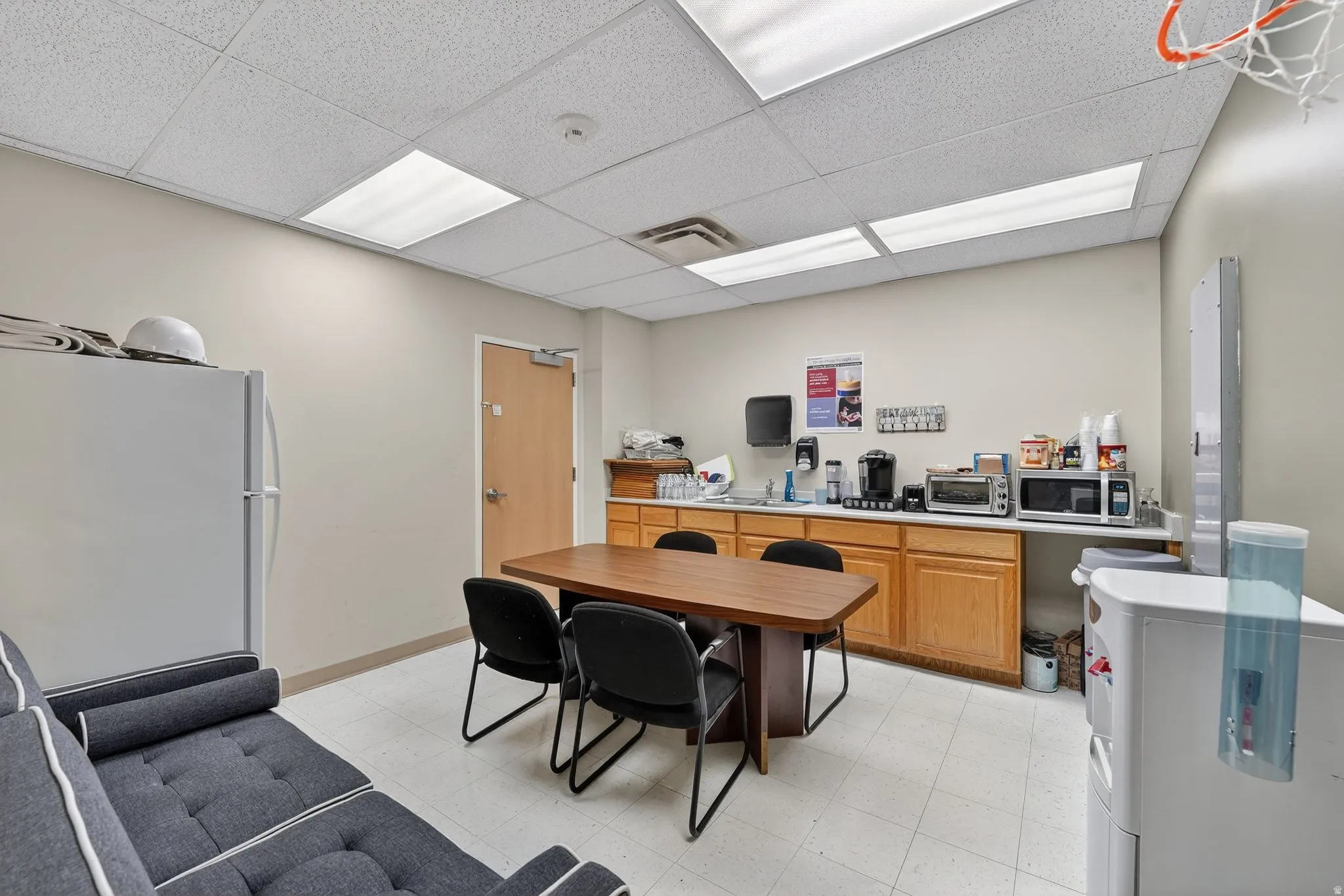 Office area with a paneled ceiling