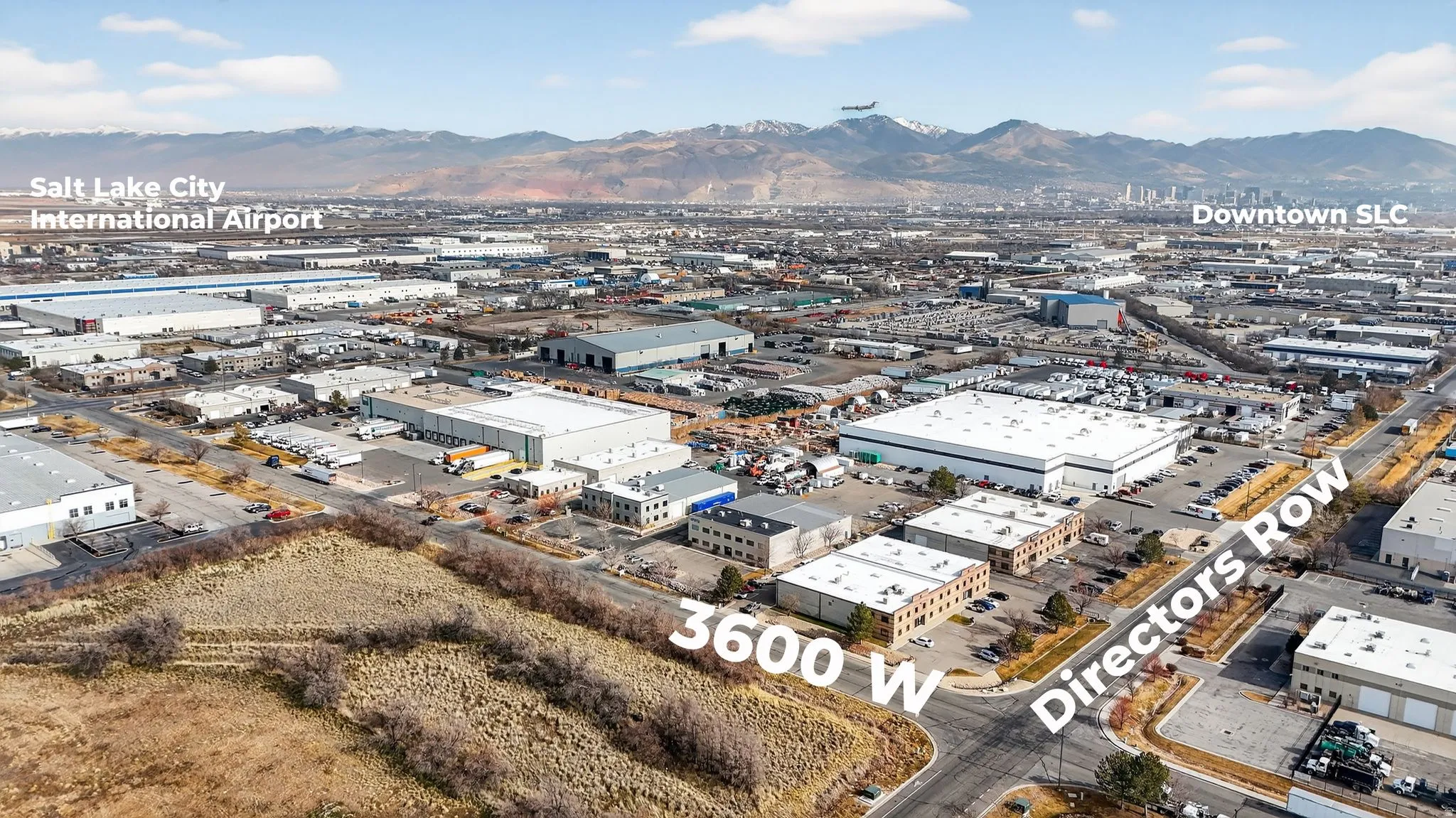 Aerial view of property's location with industrial structures and mountains