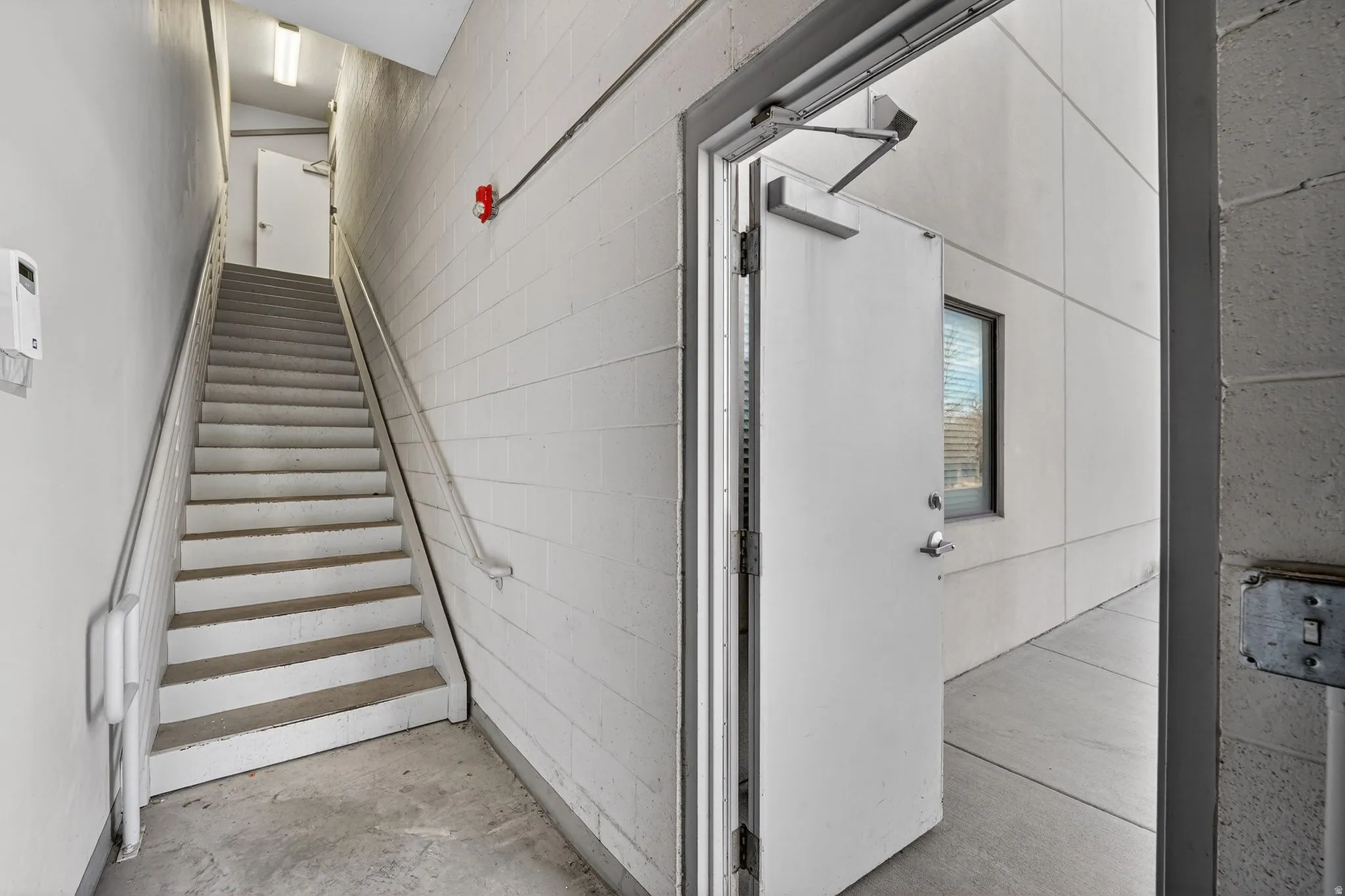 Stairs with concrete block wall and concrete floors