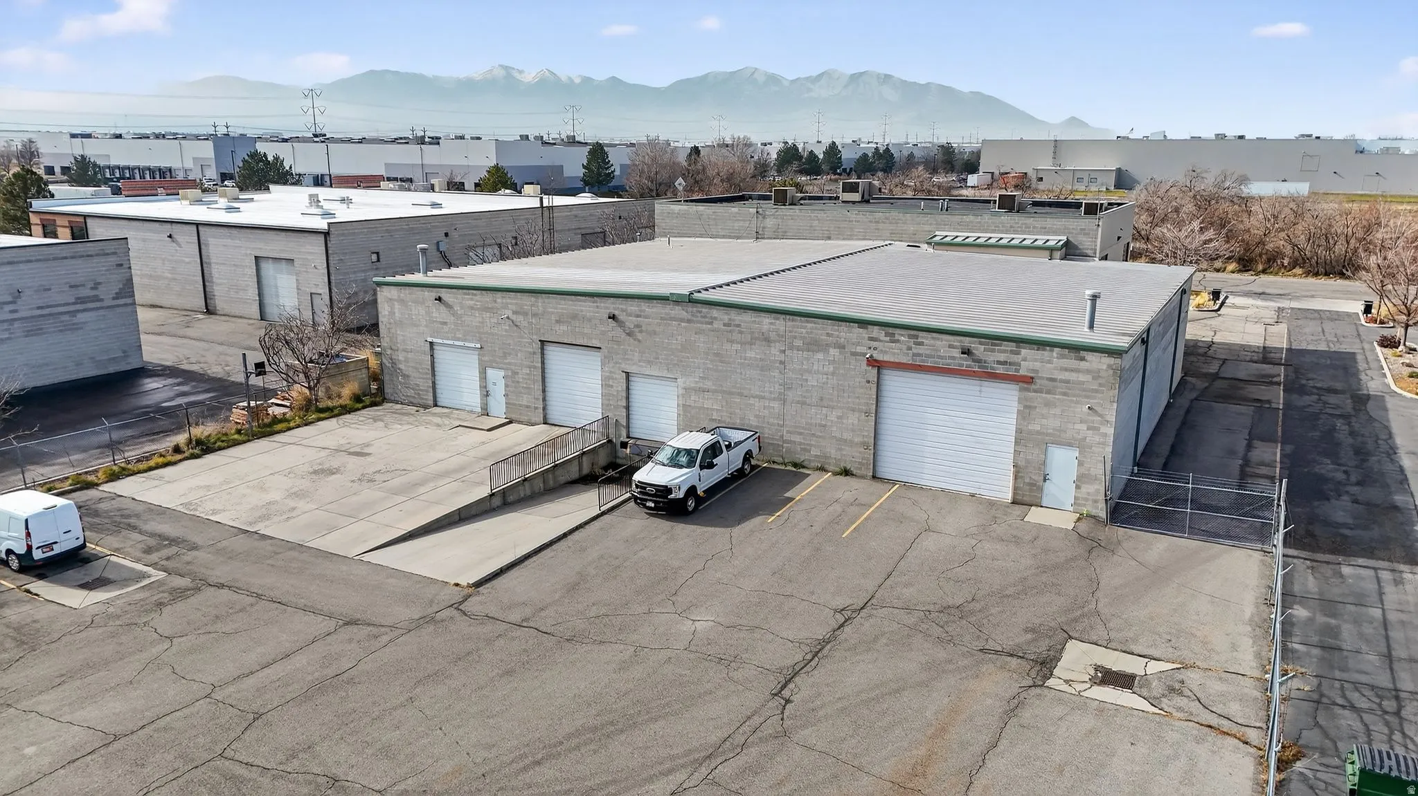 View of property with a mountain view and uncovered parking