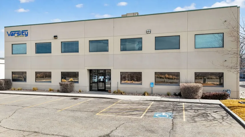 View of commercial property with uncovered parking