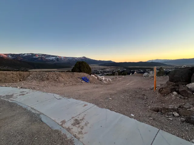 Yard at dusk featuring a mountain view
