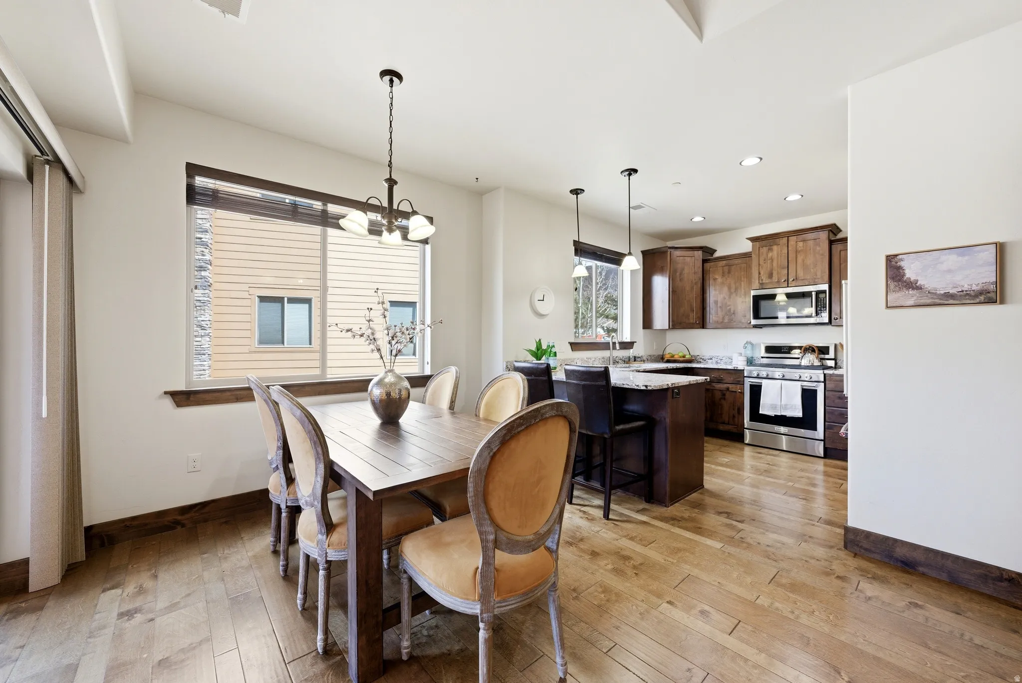Dining room featuring light wood-style flooring and suspended lighting