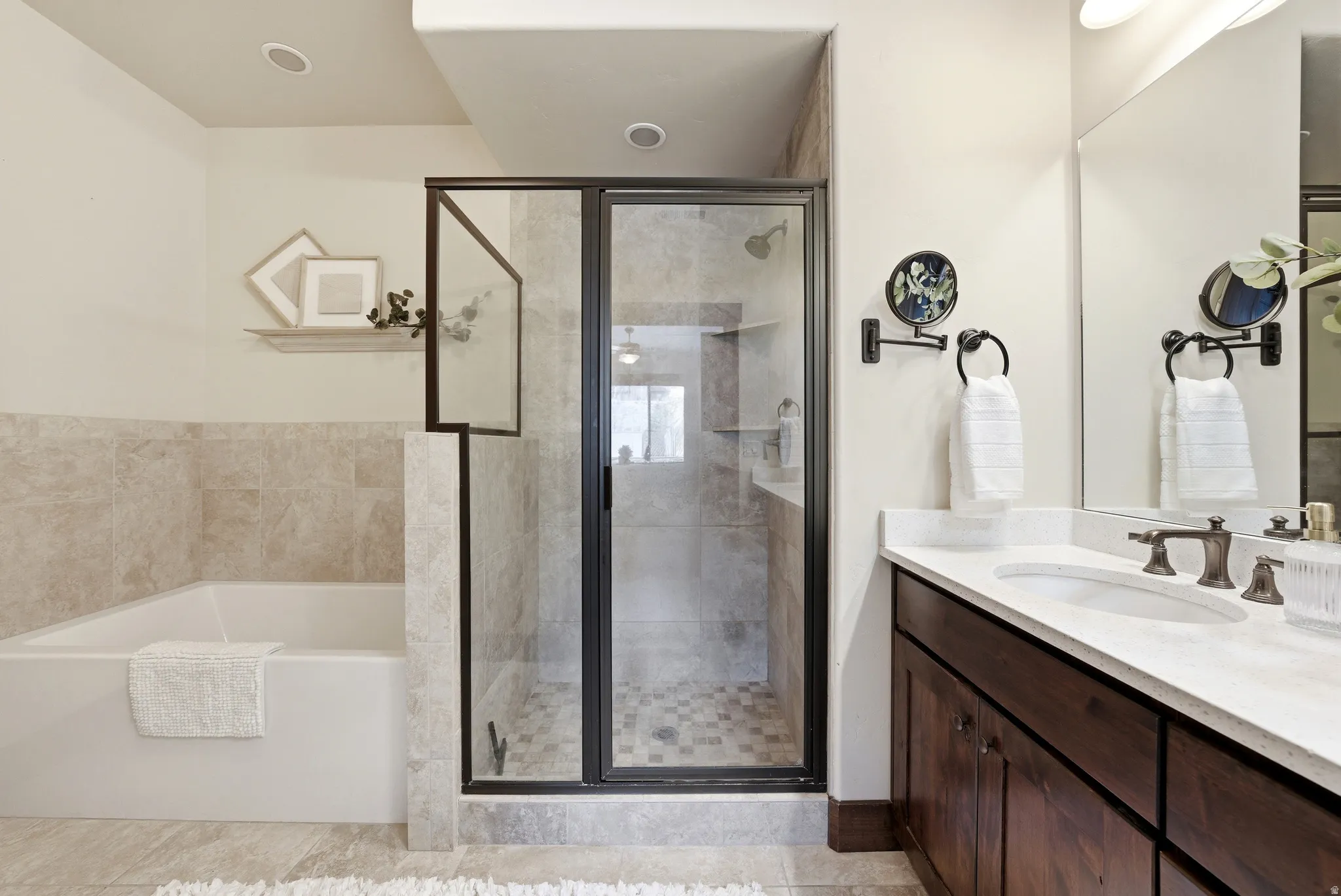 Full bathroom with vanity, a garden tub, and a stall shower