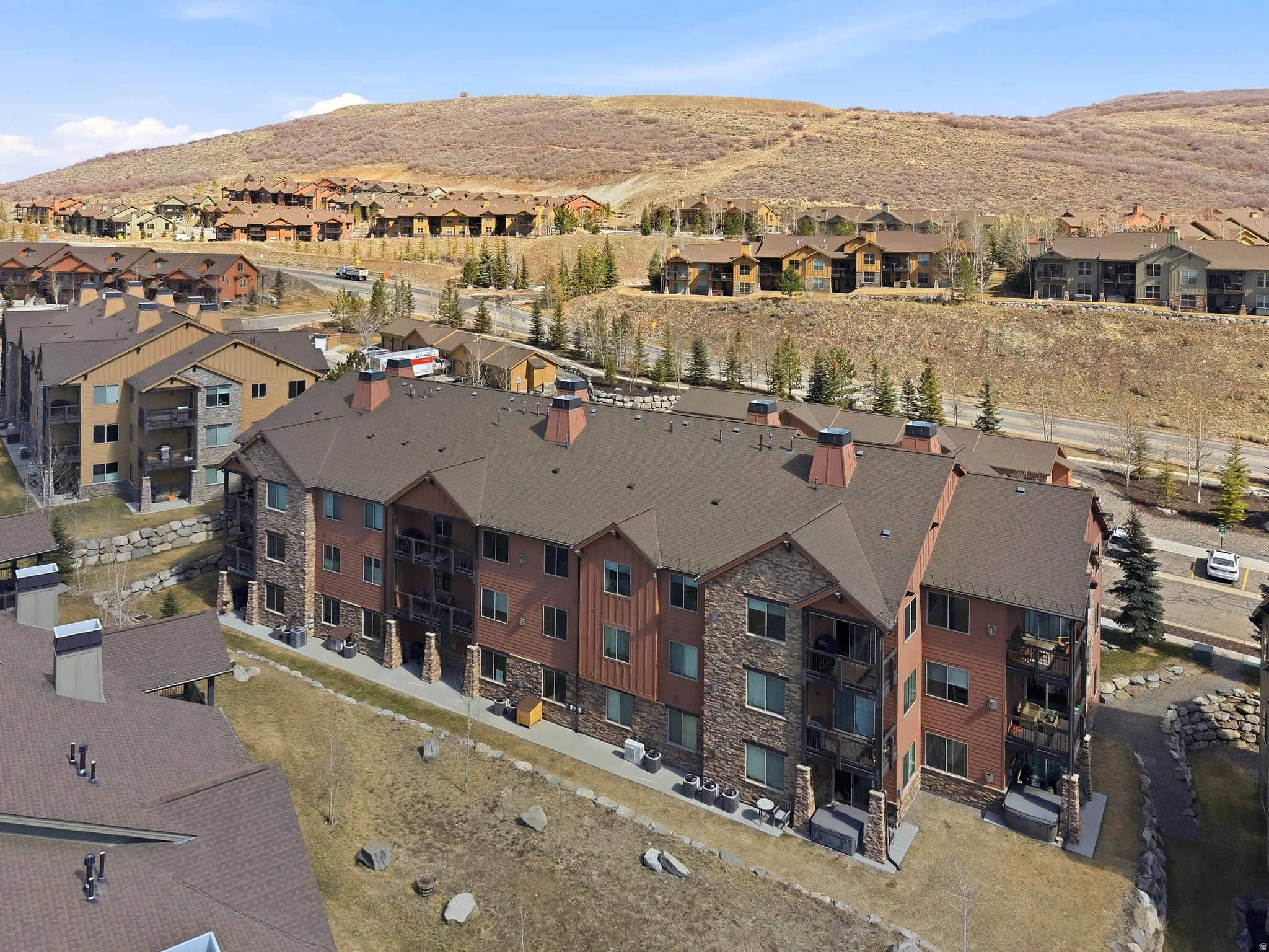 Bird's eye view of complex, quietly situated away from the highway, offering a more peaceful setting with less traffic noise.