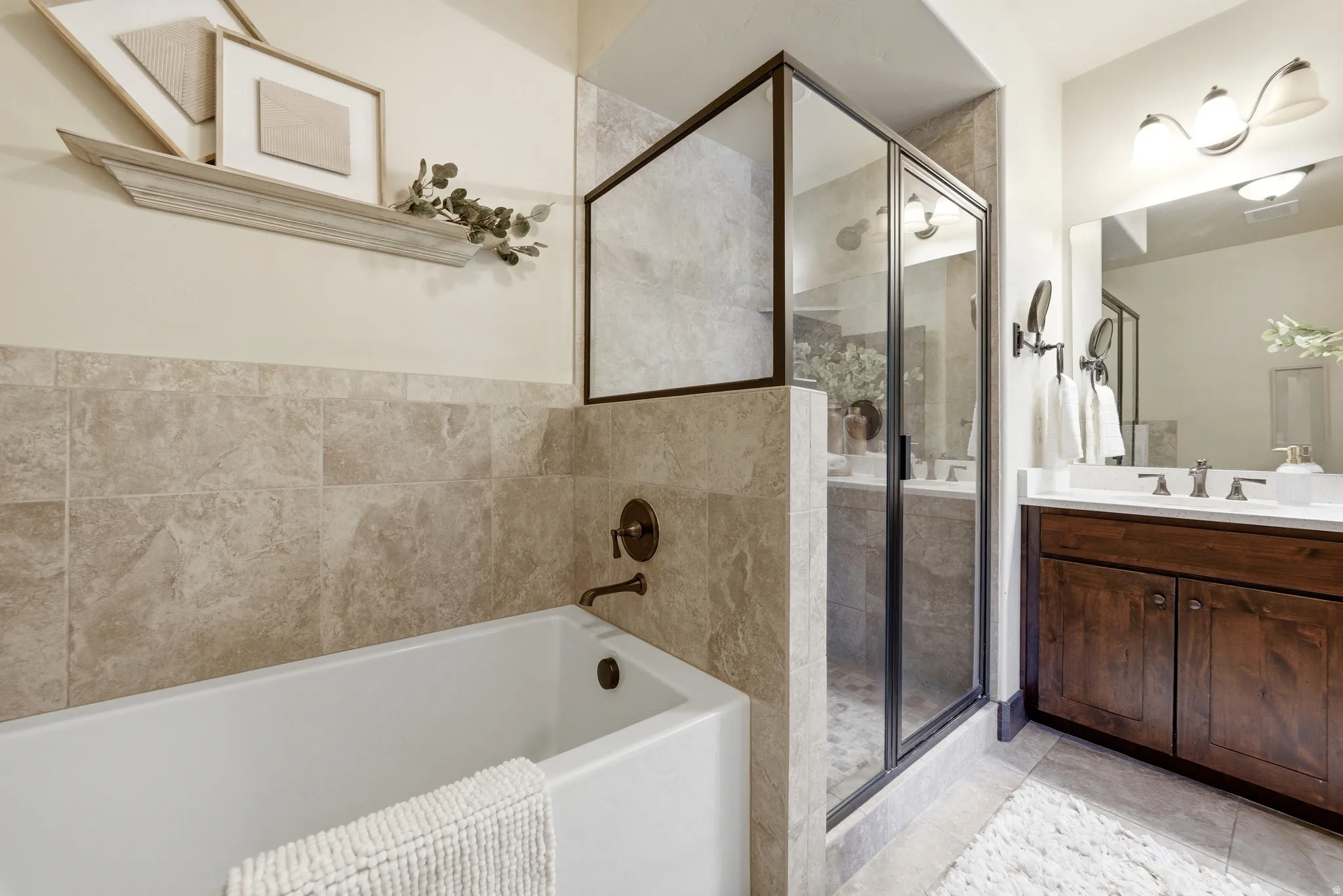 Bathroom featuring vanity, a shower stall, and a bath
