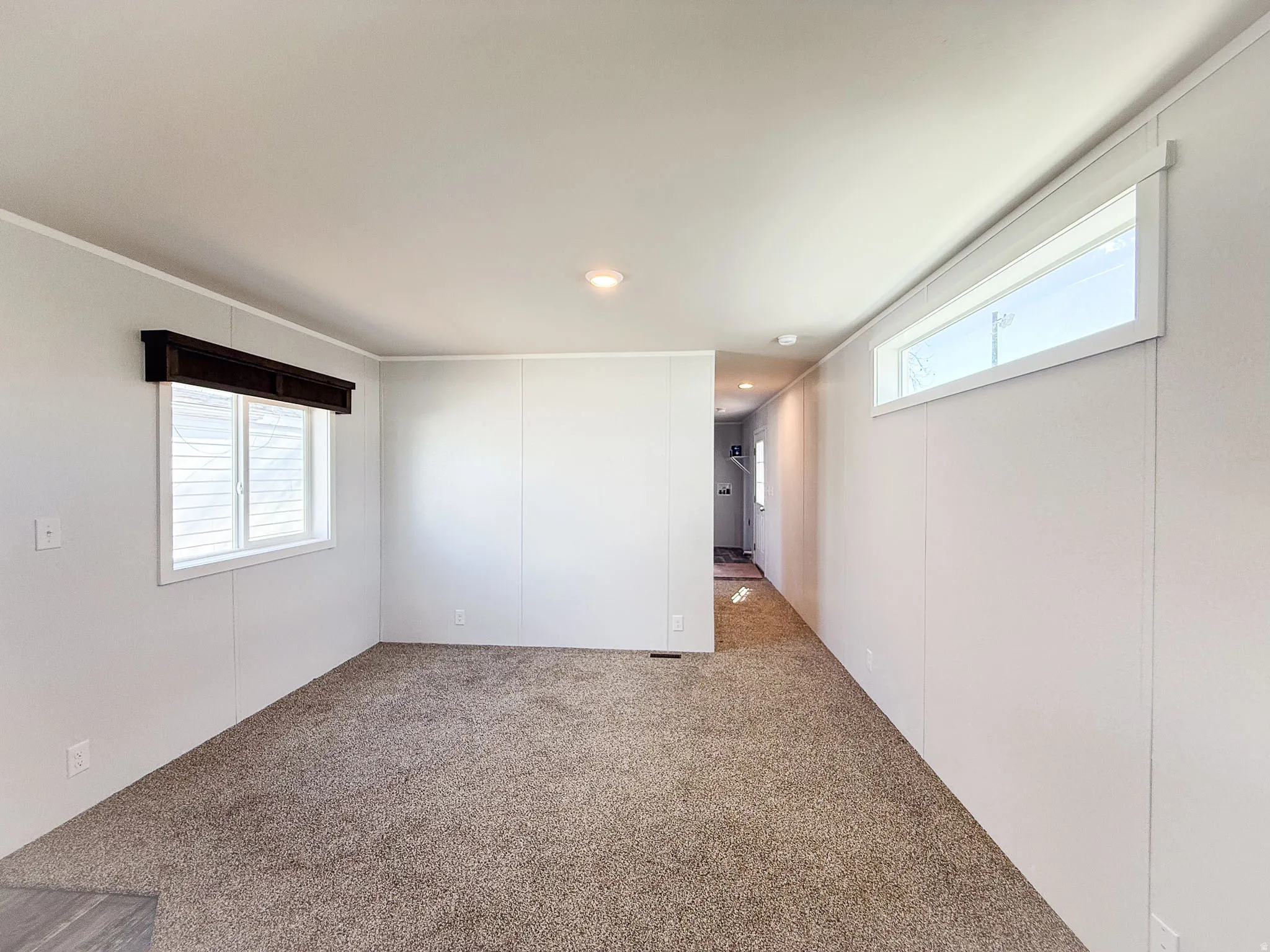 Carpeted empty room featuring a decorative wall, healthy amount of natural light, and recessed lighting
