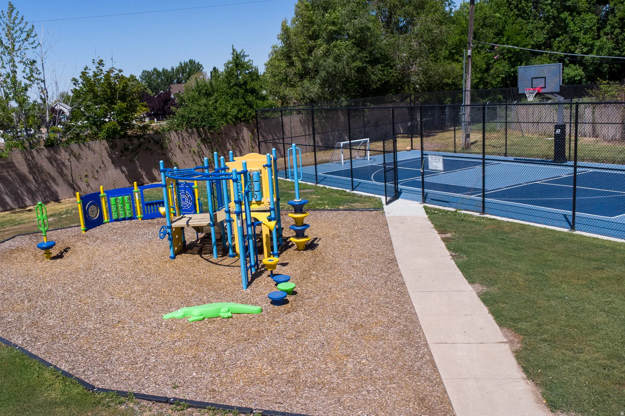 Community jungle gym featuring community basketball court