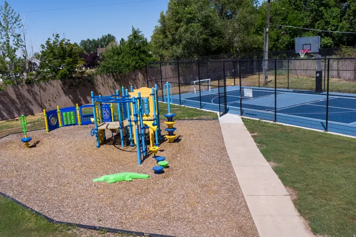 Community jungle gym featuring community basketball court