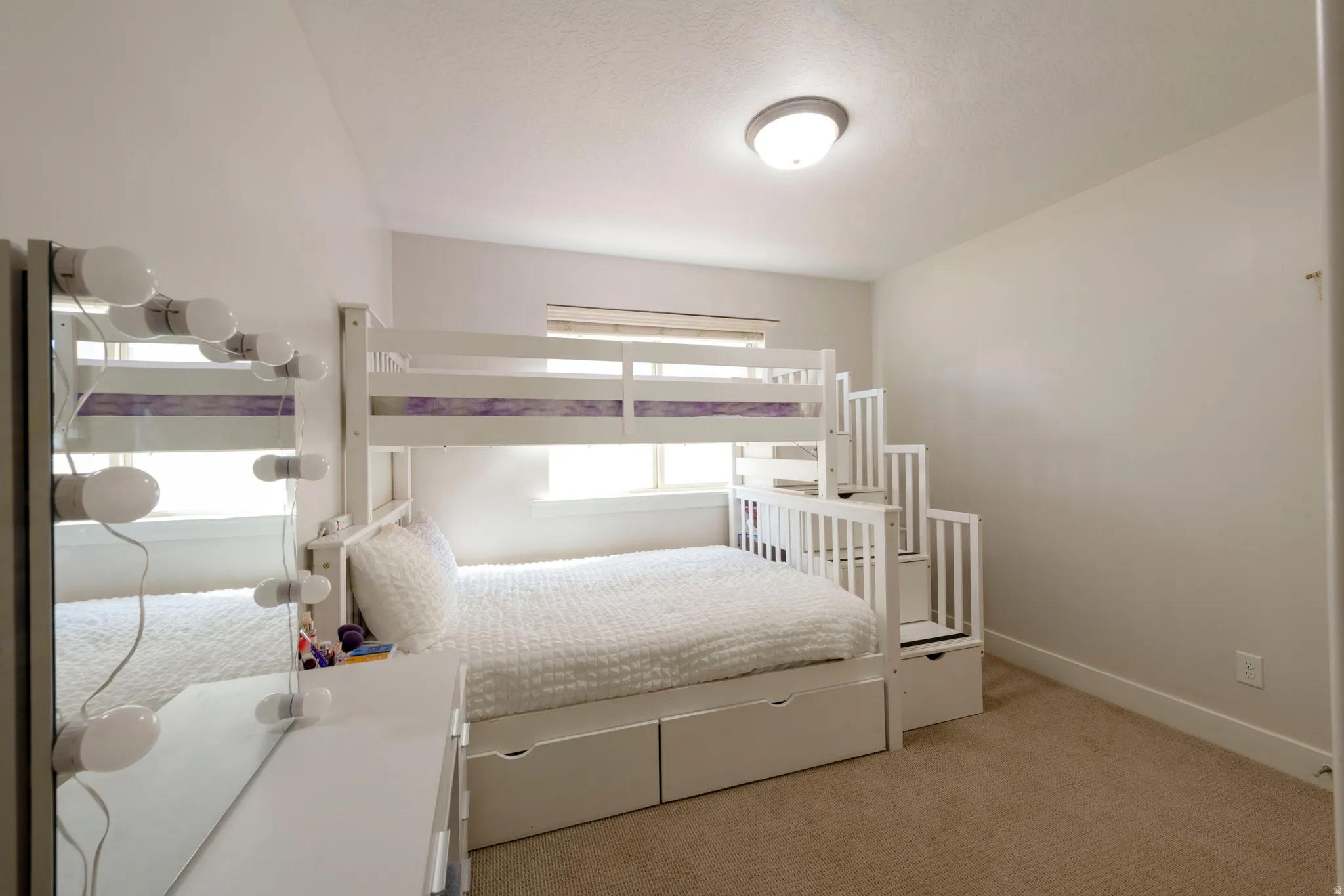 Bedroom featuring light colored carpet and baseboards