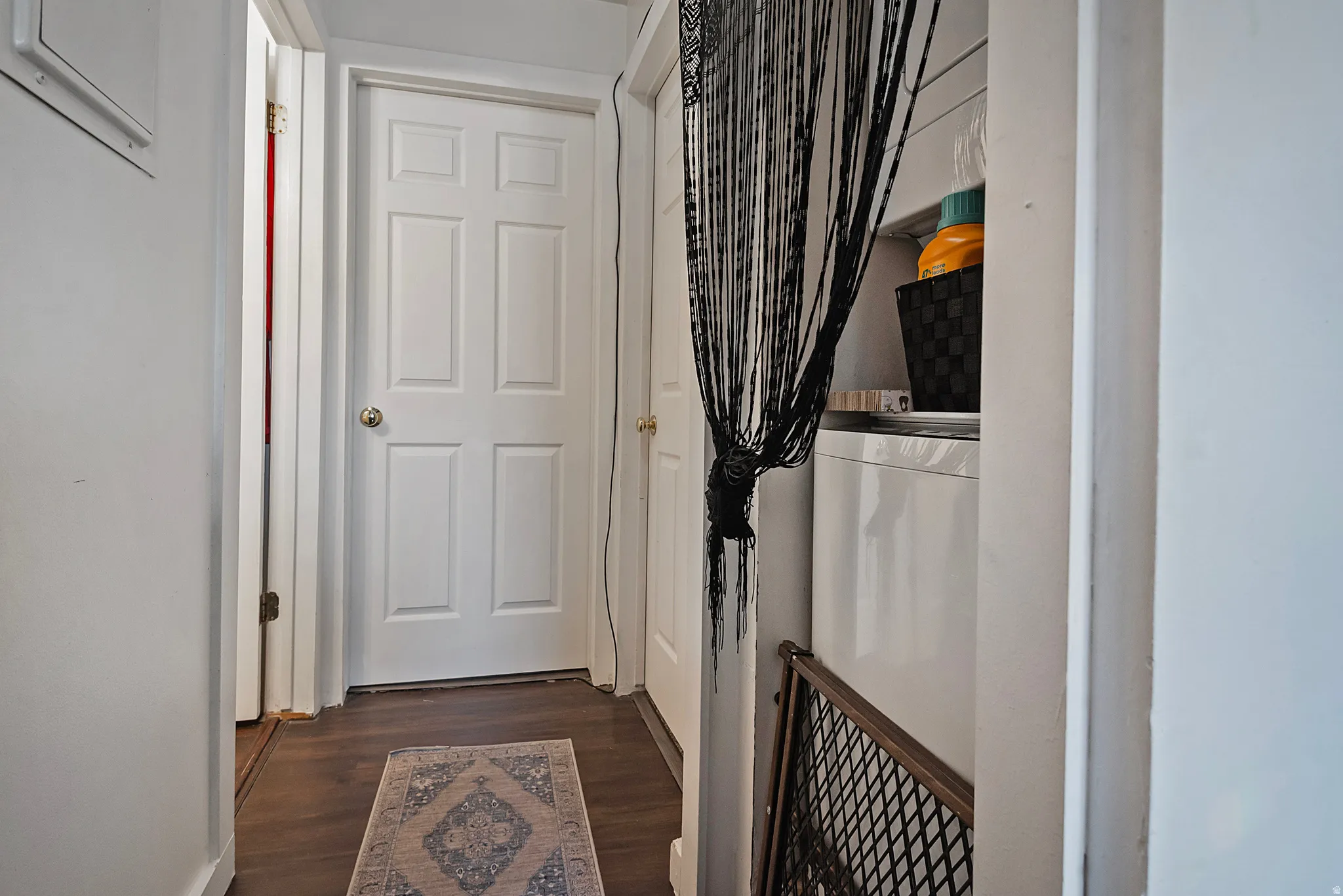 Corridor featuring dark wood-style floors