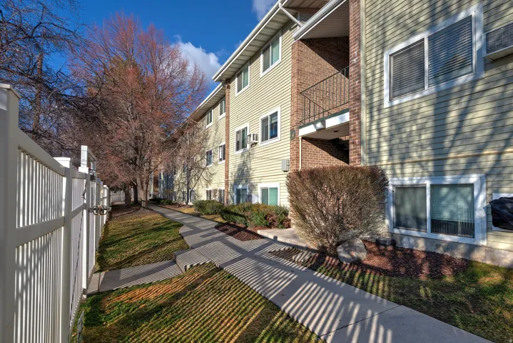 View of side of property with a balcony and brick siding