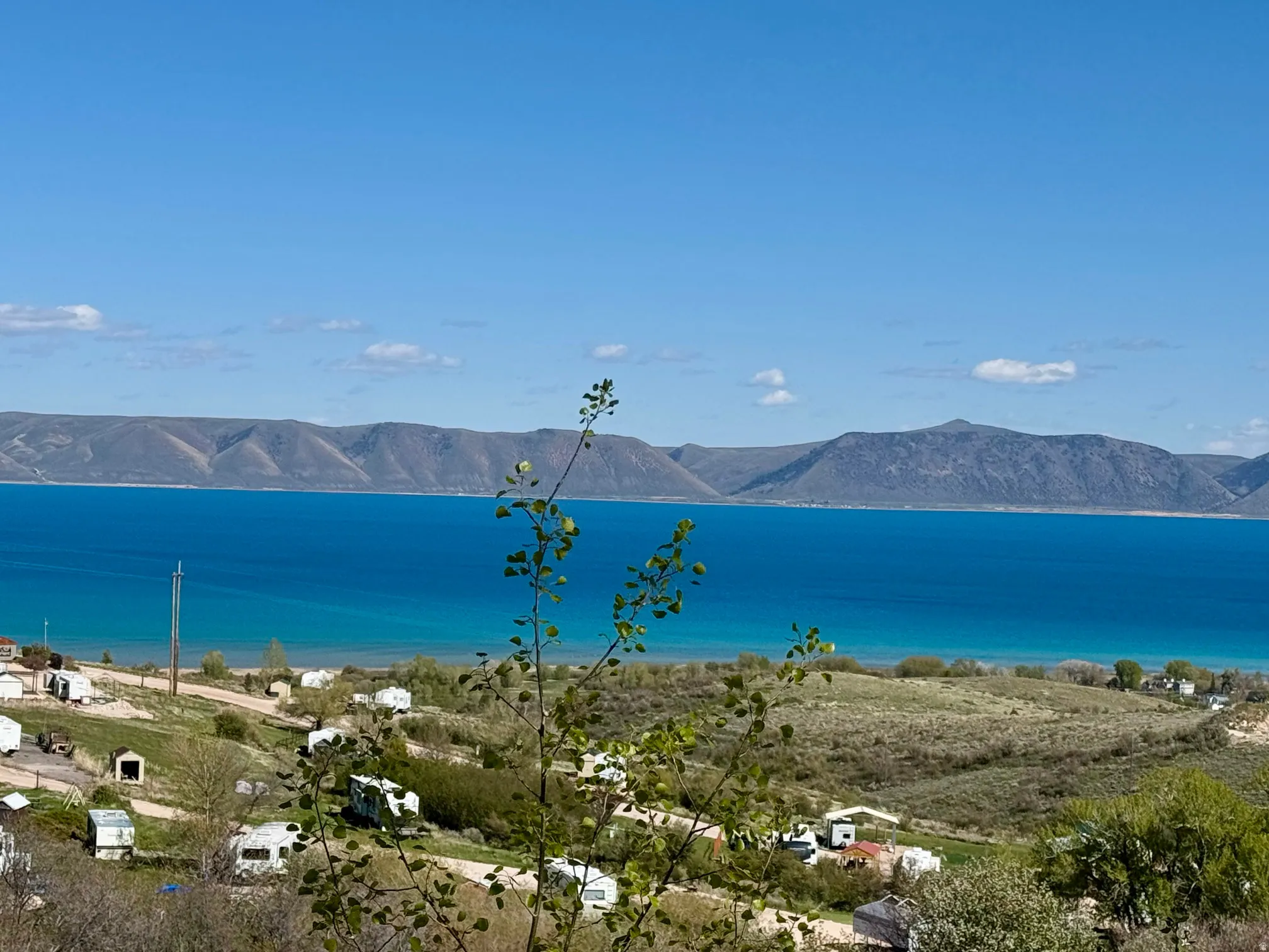 Expansive water frontage with mountain backdrop