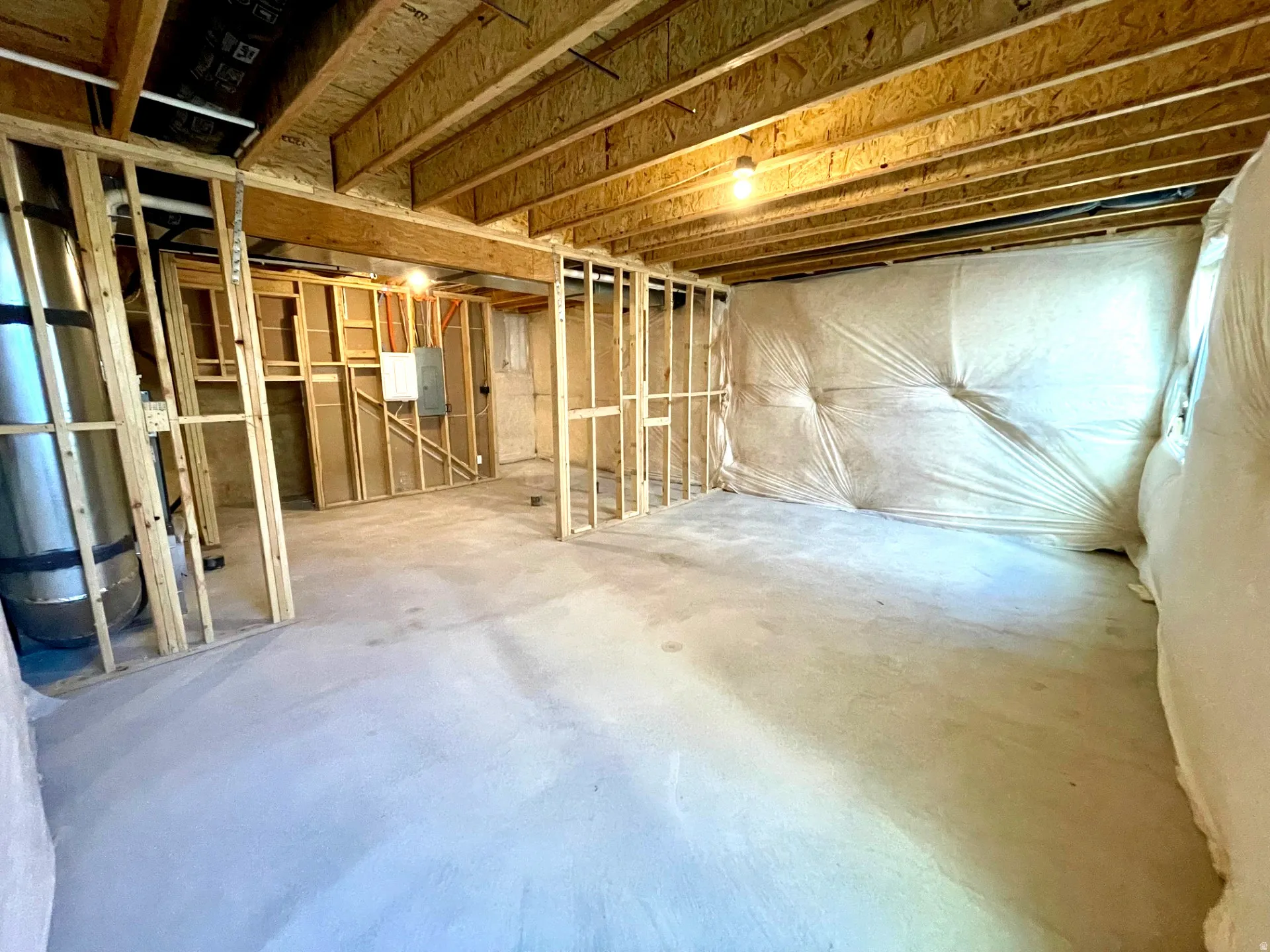 Unfinished basement featuring electric panel