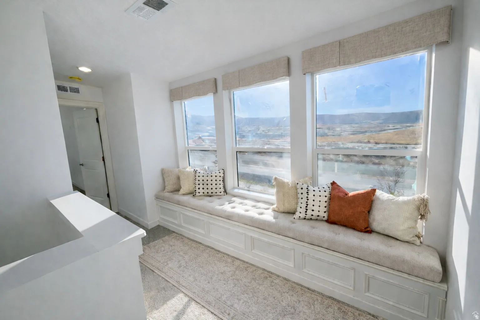 Living room featuring a decorative wall and recessed lighting