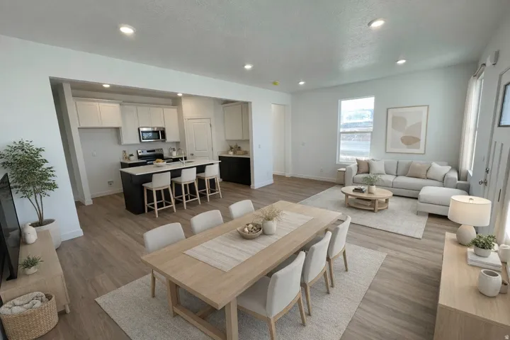 Dining area featuring dark wood-style flooring, recessed lighting, and a textured ceiling