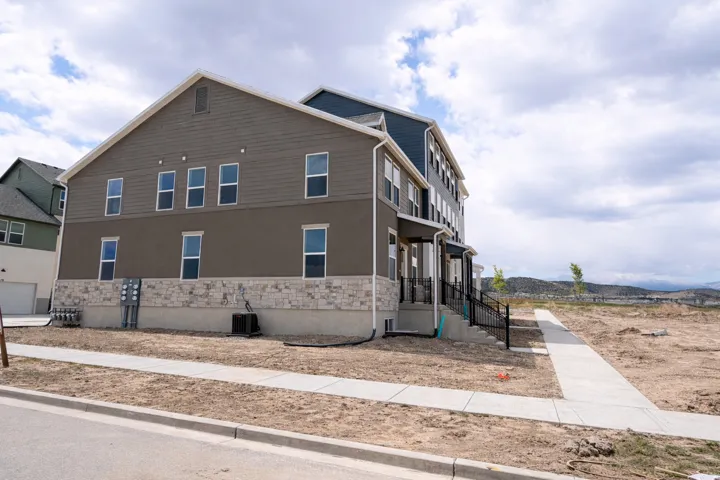 View of home's exterior featuring stone siding and stucco siding