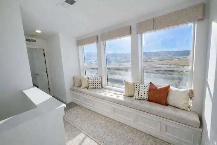Living room featuring a decorative wall and recessed lighting
