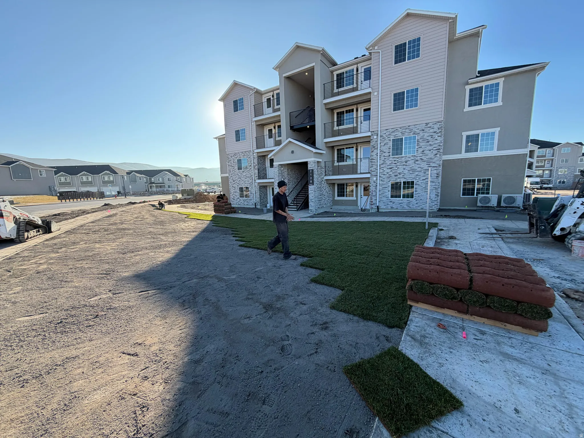 Exterior space featuring stone siding and stucco siding