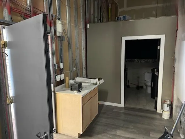 Bathroom with dark wood-style flooring and vanity