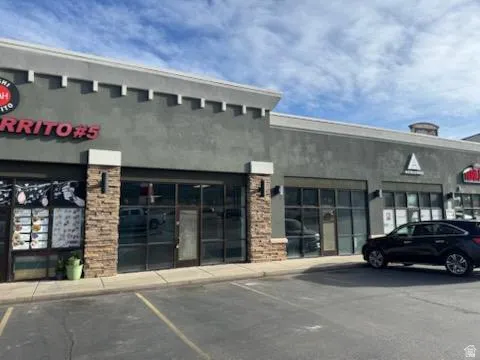 View of commercial location featuring uncovered parking