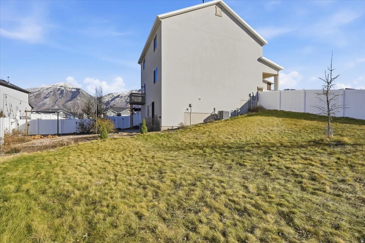 Fenced backyard featuring a mountain view