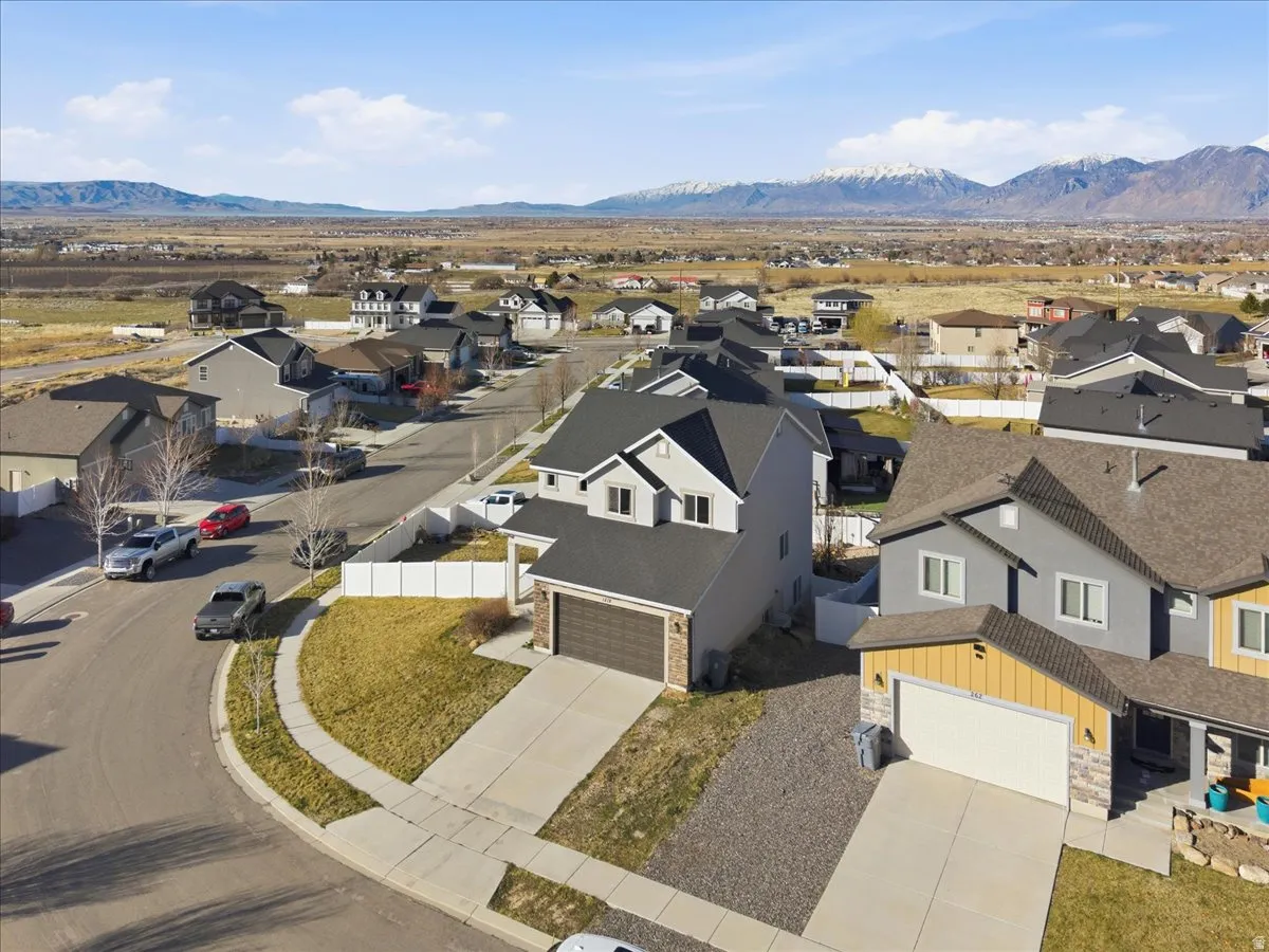 Aerial perspective of suburban area featuring a mountainous background
