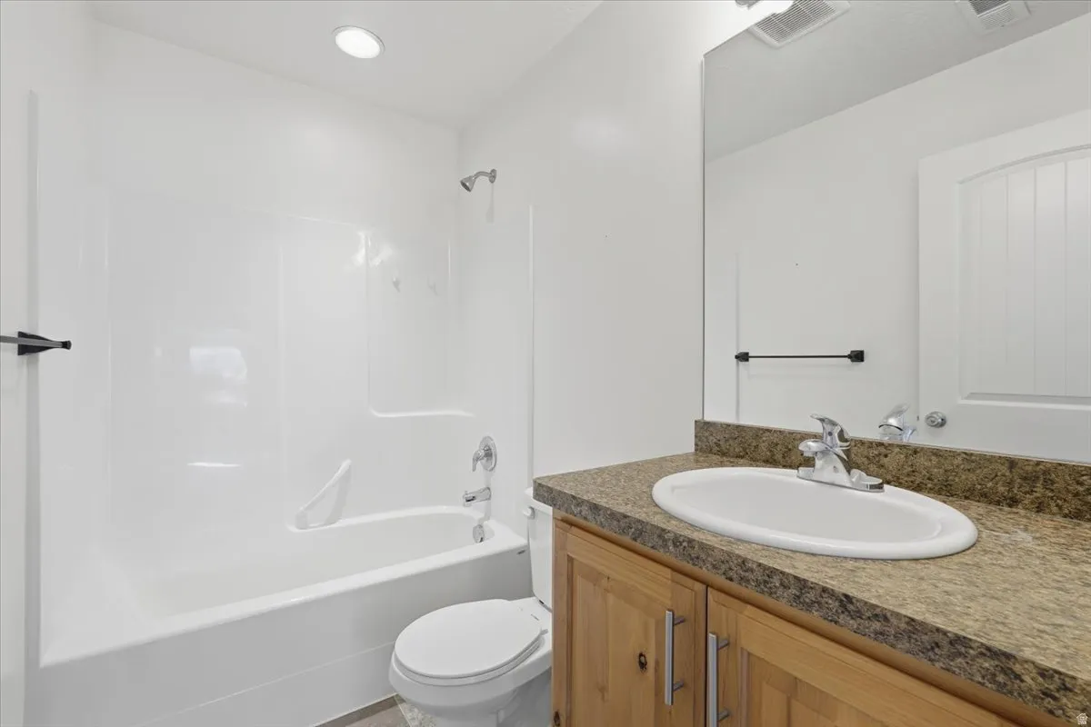 Full bathroom with vanity and washtub / shower combination