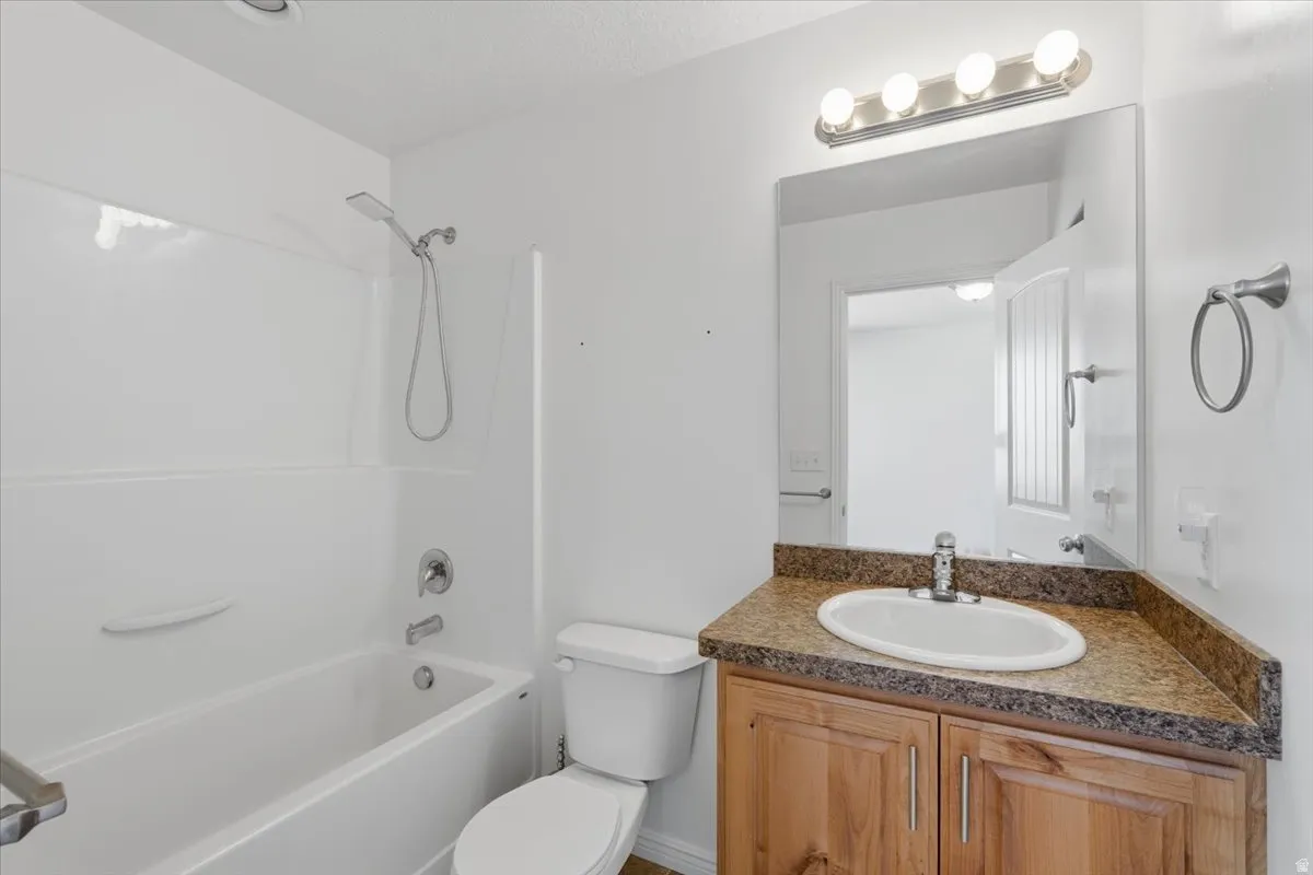 Full bath with vanity and shower / bath combination