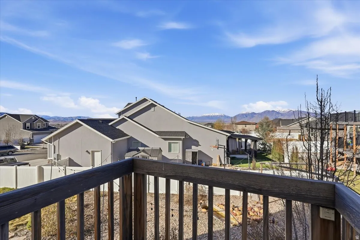 Balcony featuring a residential view and a mountain view
