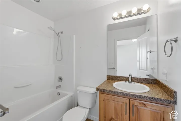 Full bath with vanity and shower / bath combination