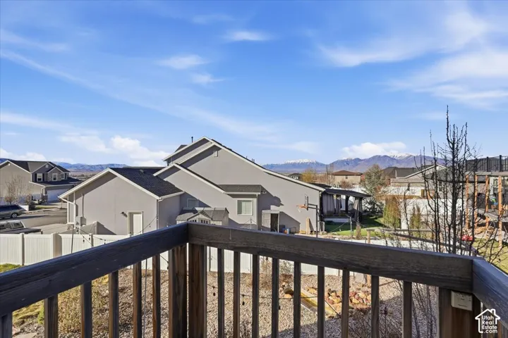 Balcony featuring a residential view and a mountain view