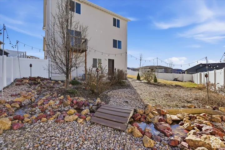 Rear view of property with a fenced backyard and stucco siding
