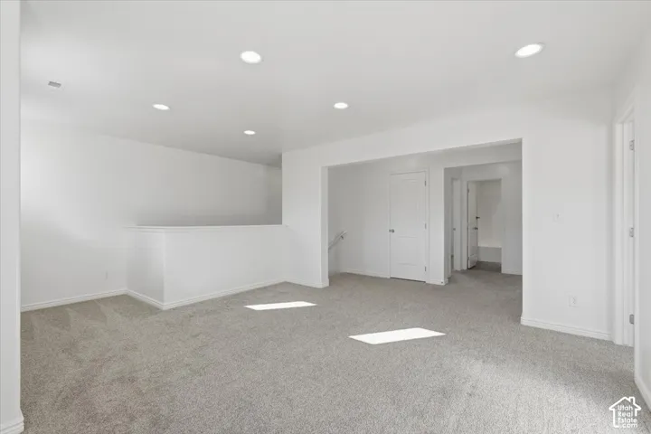 Spare room with light colored carpet and recessed lighting