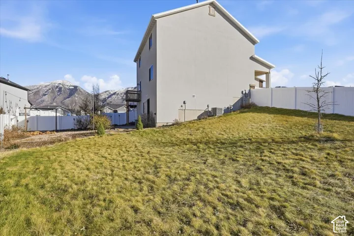 Fenced backyard featuring a mountain view